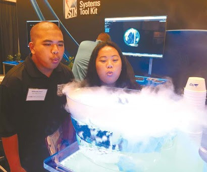 Maui High School students Bernard Sula and Renezel Lagran explore the nearly 20 science and technology exhibits as part of Space Exploration Day at the 2015 AMOS Conference on Friday at the Wailea Beach Marriott Resort & Spa.